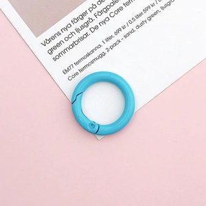Close-up of a 25mm light blue matte painted metal spring ring for DIY crafts and bags