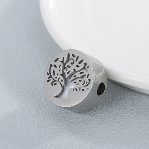Macro shot of stainless steel tree of life bead with cutout design for DIY bracelets