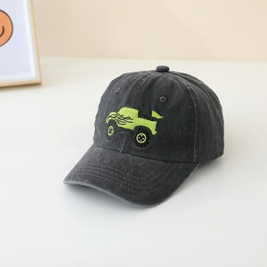 Detail of a grey washed cotton baseball cap with neon green monster truck embroidery