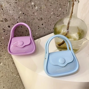 Close-up of purple and light blue silicone mini jelly bags with delicate chain straps