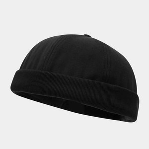 Close-up of black cotton brimless docker cap with six-panel stitching and retro texture