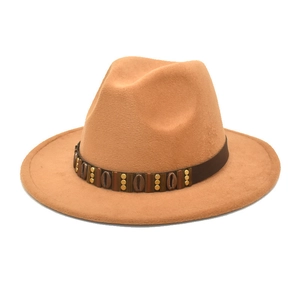 Detail of camel wool fedora hat with ethnic brown band, shells, and gold studs