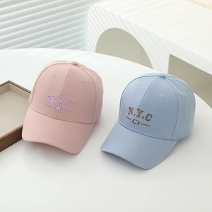 Kids NYC 21 embroidered baseball caps in pink and light blue colors on a white table