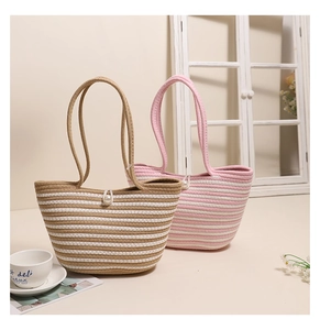 Detail of woven cotton stripe tote bags in khaki and pink with elegant pearl buckle