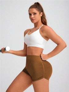 Close-up of high-waist seamless gym shorts with peach lift design and elastic fabric