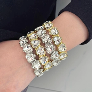 Chic multi-layer heart crystal bracelets in gold and silver finish on a female model