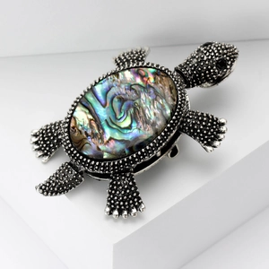 Vintage silver turtle brooch featuring colorful abalone shell inlay on white cubes