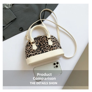 Detail of leopard print shell bag featuring white PU leather trim and top handle design