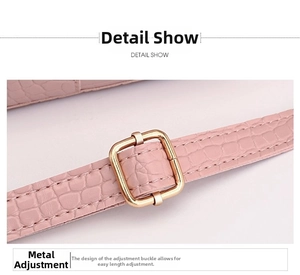 Macro shot of pink crocodile embossed leather strap with adjustable gold buckle detail