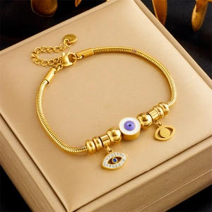 Gold stainless steel snake chain bracelet with evil eye charms and rhinestone accents