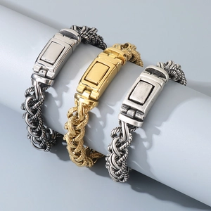 Detailed view of woven chain bracelets in silver, gold and vintage steel on a display stand