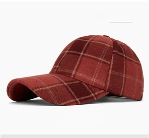 Detail of red and black plaid wool texture on a vintage style winter baseball cap