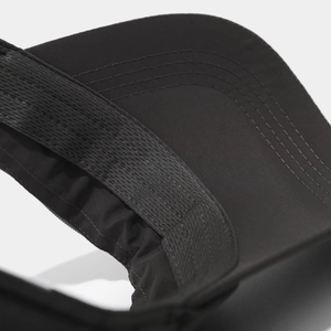 Detailed macro view of reinforced stitching on the brim and sweatband of a black sports cap