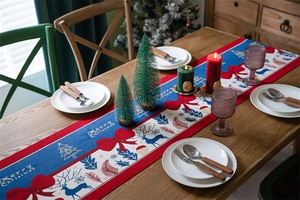 Detailed texture of polyester Christmas table runner with deer and bowknot patterns