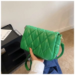 Detailed view of the green quilted pattern bag with premium golden metal hardware detail