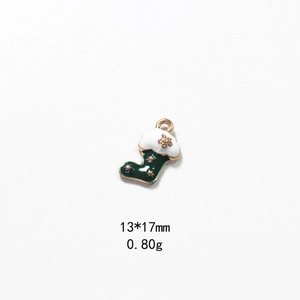 Detail of green and gold enamel Christmas stocking pendant charm, 13x17mm size