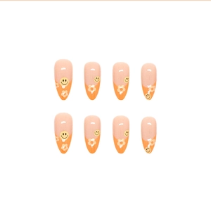 Almond press-on nails with orange gradient finish, yellow smiley face and white flowers