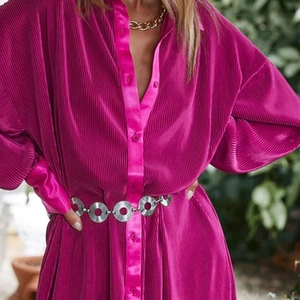 Detail of fuchsia pleated shirt dress with silver geometric metal link waist chain