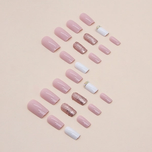 Pink and white square press-on nails set with glitter and rhinestone accents