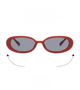 Close-up of retro oval sunglasses with bright red frame and dark grey lenses for fashion