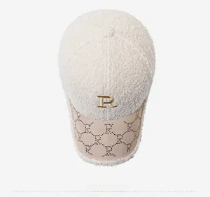 Top view detail of plush baseball cap with gold R logo and patterned brim embroidery