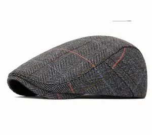 Close-up of gray herringbone wool flat cap with vintage multicolor plaid pattern