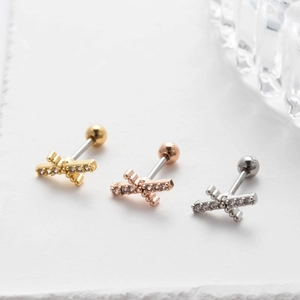 Detailed view of crisscross surgical steel ear studs with sparkling cubic zirconia inlay