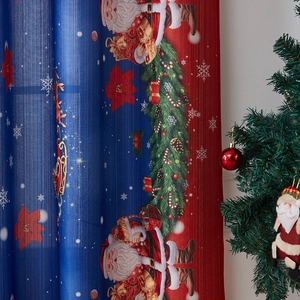Detail of Christmas curtain featuring Santa Claus and reindeer print with festive patterns