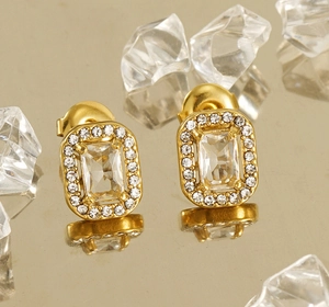 Macro shot of double-layer gold stud earrings with square zircon and halo stones