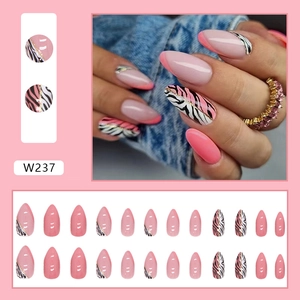 Close-up of pink and zebra print almond press-on nails with gold foil accents