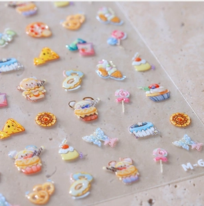 Detail view of 3D embossed cute dessert nail art stickers with cupcakes and donuts