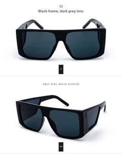 Detailed views of chunky black oversized sunglasses with dark gray lenses and thick frames