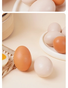 Detailed macro view of realistic artificial boiled egg models with miniature wood steamer