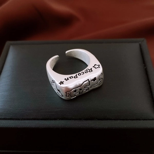 Macro shot of vintage silver ring with Recopan star engraving on black leather box