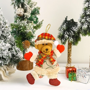 Detail of plush Christmas bear ornament with red hat and scarf for tree decoration