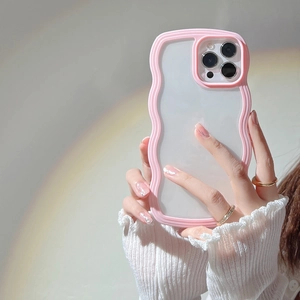 Pink wavy border phone case with clear back held by model under soft rainbow light
