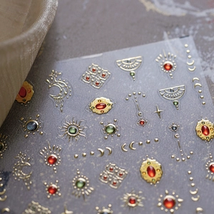 Bohemian gold embossed nail stickers with sun moon and star patterns on gray background