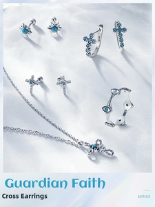 Macro detail of S925 sterling silver cross earrings with turquoise inlay stones