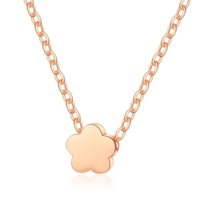 Detail of rose gold necklace featuring a minimalist matte flower pendant on a dainty chain
