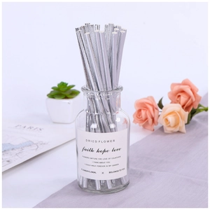 Silver reed diffuser straws in a clear glass bottle with a decorative English label set