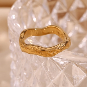 Detailed macro view of 18K gold plated ring featuring unique hammered wave texture