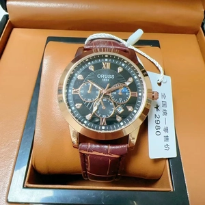 Detail of luxury men's quartz watch with black dial and leather strap in a gift box
