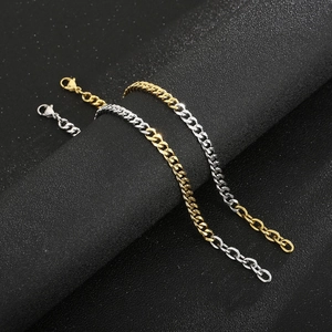 Two-tone gold and silver Cuban link bracelet with lobster clasp on a black display stand