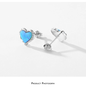 Detailed shot of S925 silver heart stud earrings with blue opal and small zircon accents