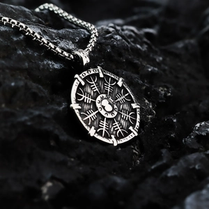 Vintage Viking compass shield pendant necklace in stainless steel on dark rock