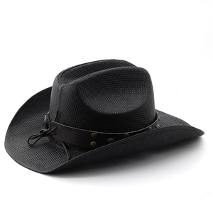Close-up of black woven cowboy hat featuring a faux leather band with bronze metal studs