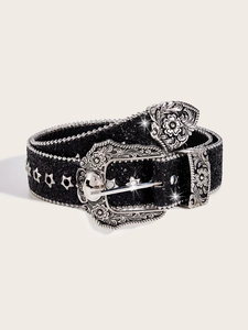 Detail of vintage black glitter belt with silver floral buckle and star rivets