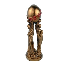 Detail of bronze-colored trophy featuring two figures holding a THE WORLD engraved orb