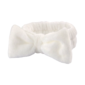 Plush white microfiber headband with a large bow for skincare and washing face