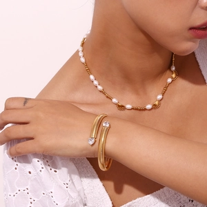 18K gold plated striped cuff bracelet with heart zircon and pearl necklace on a model